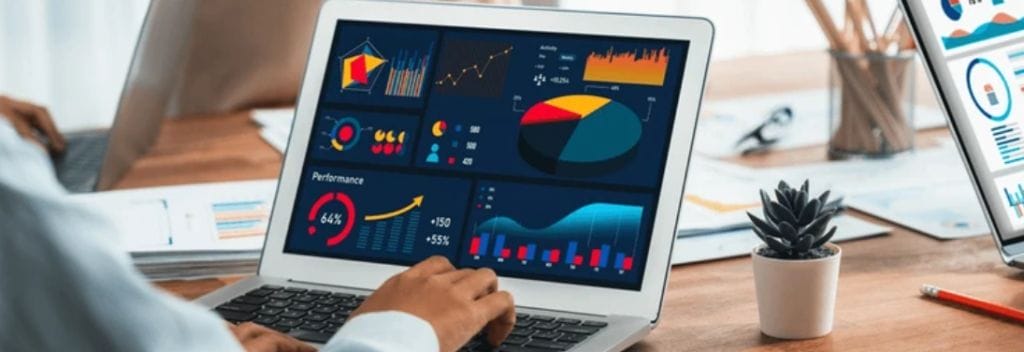 Person reviewing business analytics on laptop, showing performance data. Ideal for corporate training and development.