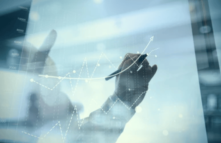 Person drawing upward trending graph on glass screen; Business education services.