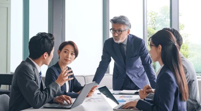 Business team collaborating during a meeting, discussing management strategies.