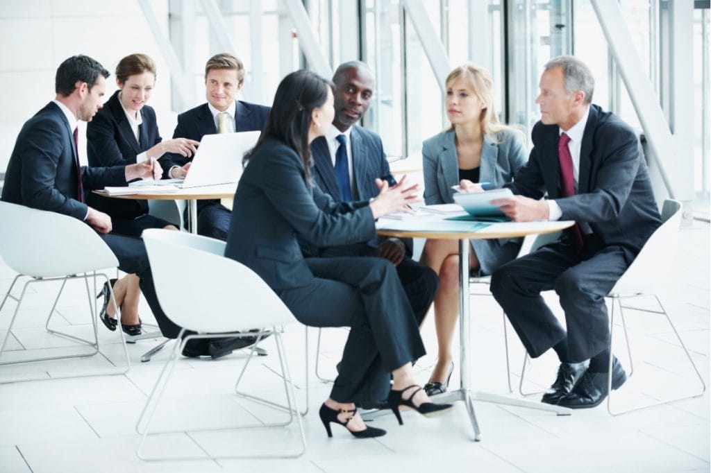 Diverse business team collaborating around a table during a meeting.