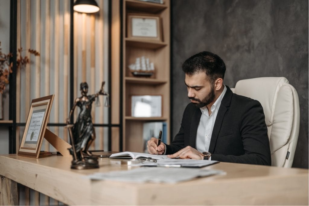 Focused employee reviewing documents at his desk.