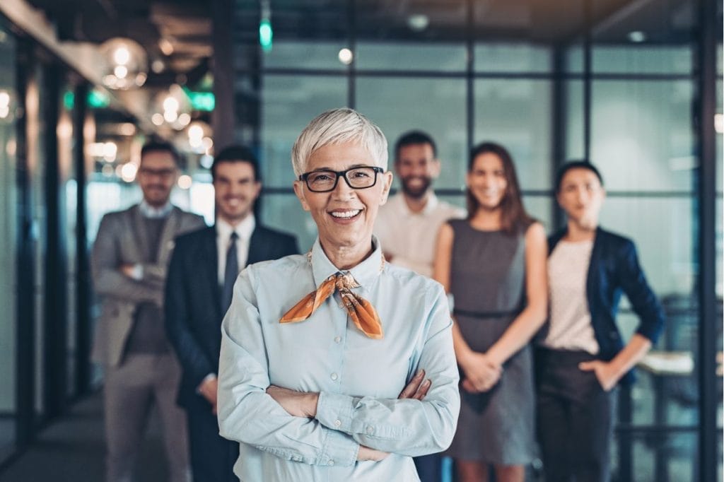 Confident female leader with diverse team