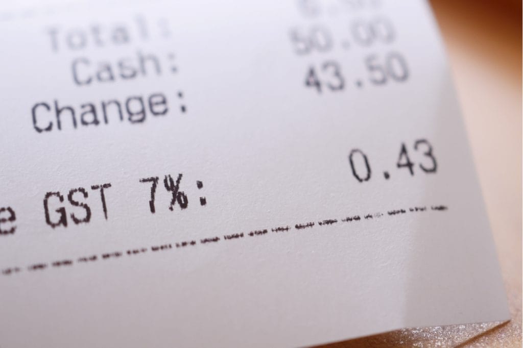 Close-up of a receipt showing GST 7% and a change of 0.43.